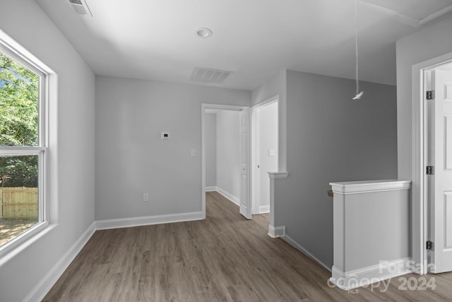 unfurnished room with hardwood / wood-style floors