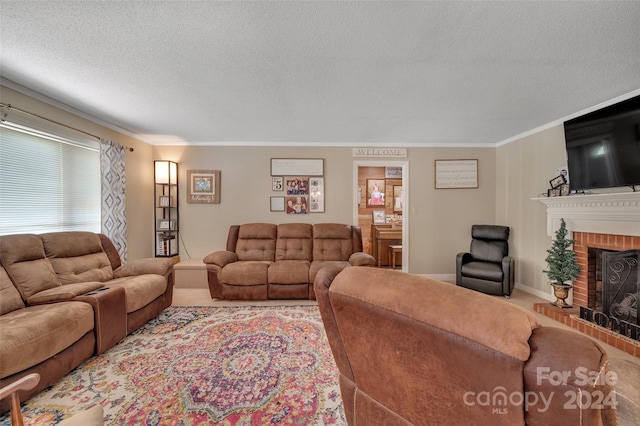 living area with ornamental molding, a brick fireplace, carpet floors, and a textured ceiling