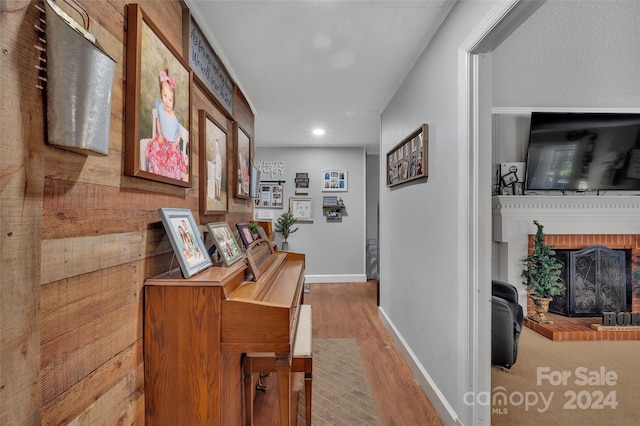 corridor with baseboards and wood finished floors