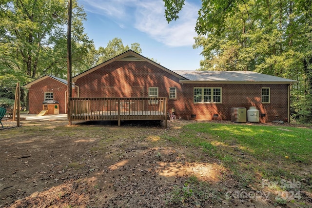 back of house featuring brick siding, crawl space, a playground, and a wooden deck