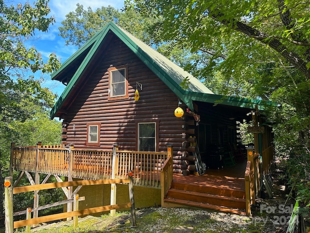 rear view of property featuring a deck