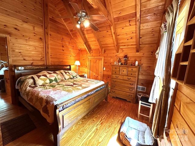 bedroom with wooden walls, wood-type flooring, ceiling fan, vaulted ceiling with beams, and wood ceiling