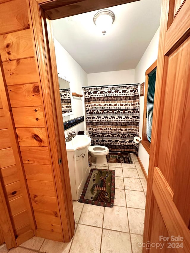 full bathroom featuring vanity, toilet, tile patterned flooring, and shower with separate bathtub