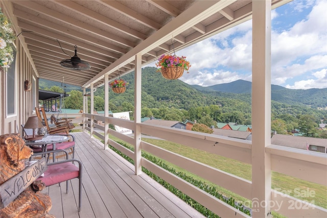 deck with a mountain view and ceiling fan