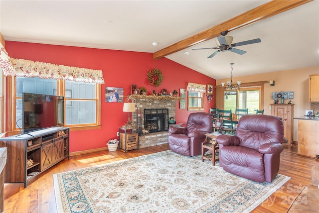 living room with hardwood / wood-style floors, ceiling fan, lofted ceiling with beams, and a brick fireplace