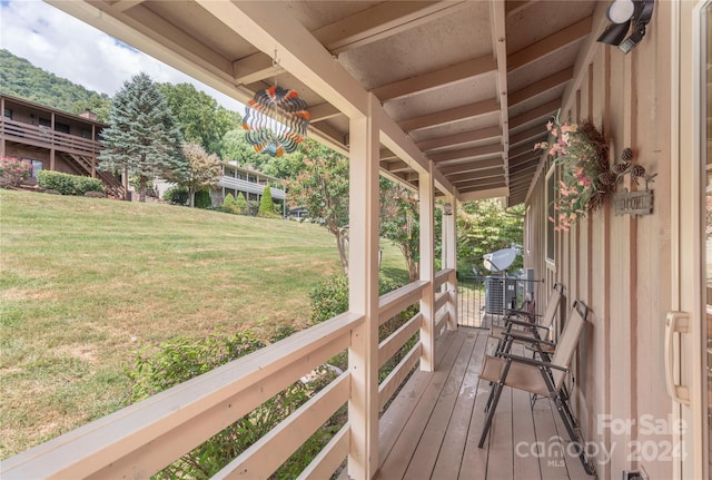 wooden deck with a yard and a porch