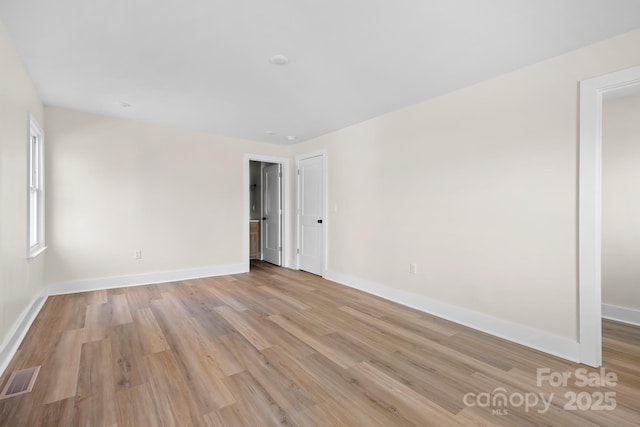 empty room with light hardwood / wood-style flooring