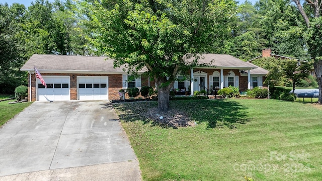 ranch-style house featuring a garage, a front yard, and a porch