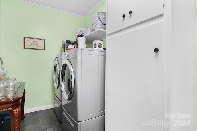 washroom featuring washer and dryer, crown molding, and cabinets