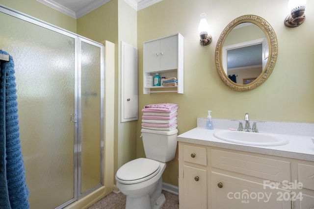 bathroom featuring toilet, a shower with door, crown molding, and vanity