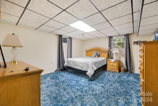 carpeted bedroom featuring a paneled ceiling