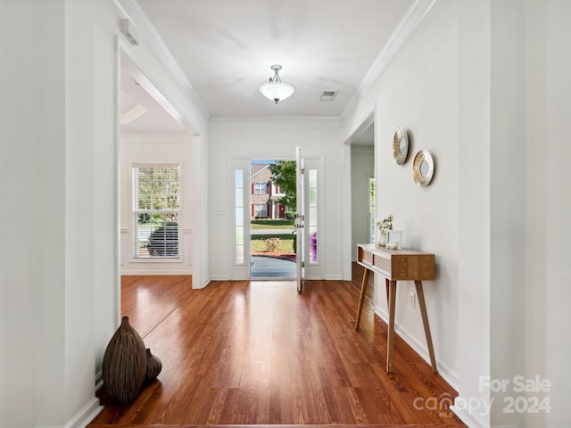 foyer featuring ornamental molding and hardwood / wood-style floors