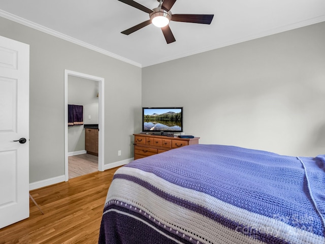 bedroom with light wood-type flooring, ceiling fan, ensuite bathroom, and crown molding