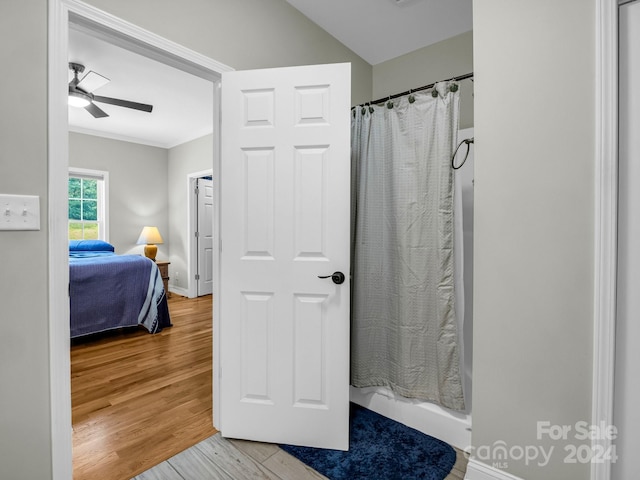 bathroom with ceiling fan, curtained shower, and hardwood / wood-style flooring