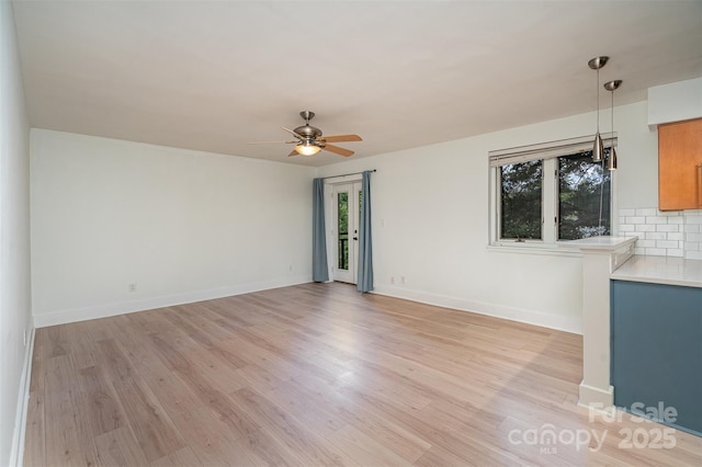 empty room featuring ceiling fan and light wood-type flooring