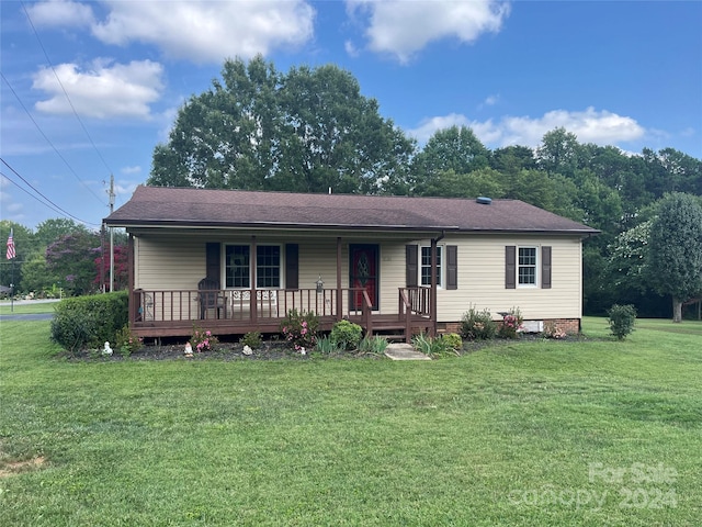 view of front of house with a front yard and a deck