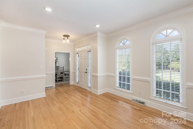 entryway with recessed lighting, visible vents, ornamental molding, wood finished floors, and baseboards