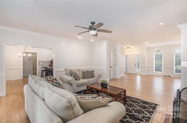 living area featuring baseboards, ornamental molding, ceiling fan with notable chandelier, light wood-type flooring, and recessed lighting