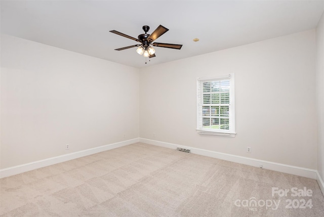 unfurnished room featuring carpet floors, visible vents, and baseboards