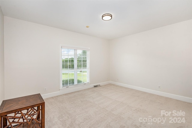 carpeted empty room with baseboards and visible vents