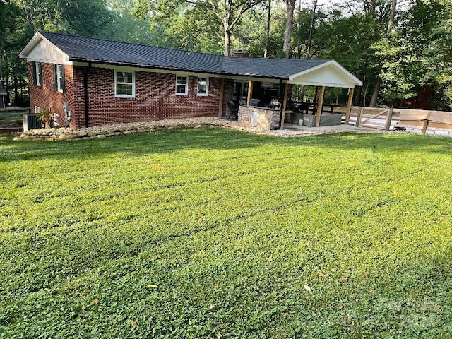 back of property with a lawn and central air condition unit