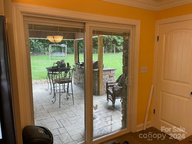 doorway to outside featuring crown molding