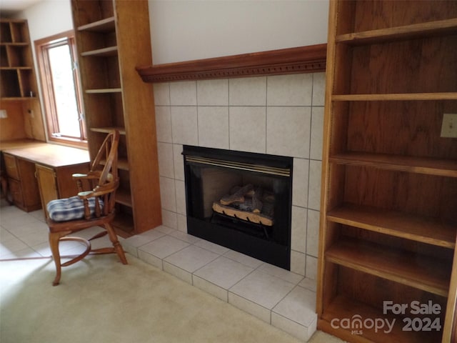 unfurnished living room with tile walls, light tile patterned floors, and a tile fireplace