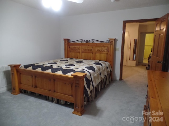 bedroom featuring light colored carpet