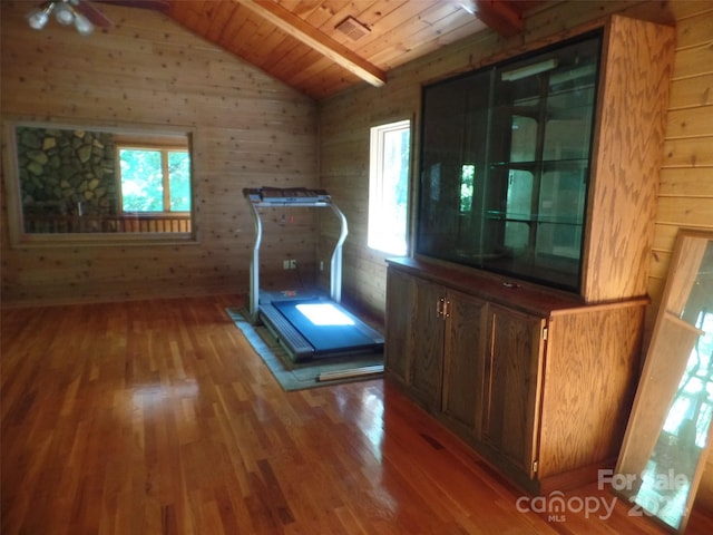 interior space with wooden ceiling, lofted ceiling with beams, wood-type flooring, and ceiling fan