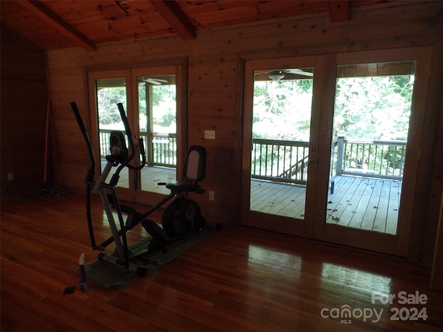 interior space with wood ceiling, dark hardwood / wood-style floors, and wooden walls