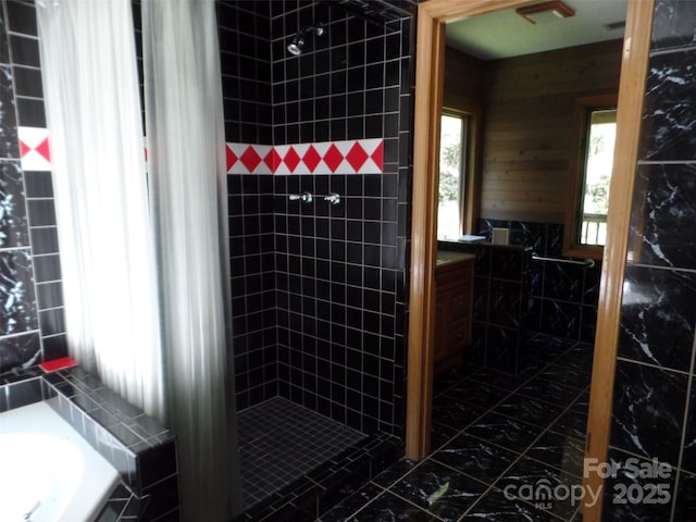 721 Kuenzel Eller Dr, Millers Creek, NC 28651 - full bathroom featuring a stall shower, tile walls, and marble finish floors