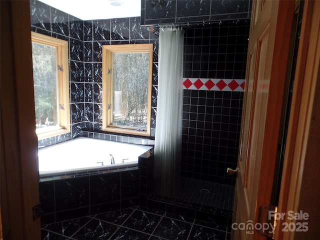 721 Kuenzel Eller Dr, Millers Creek, NC 28651 - bathroom featuring marble look tiles, tiled shower, and a garden tub