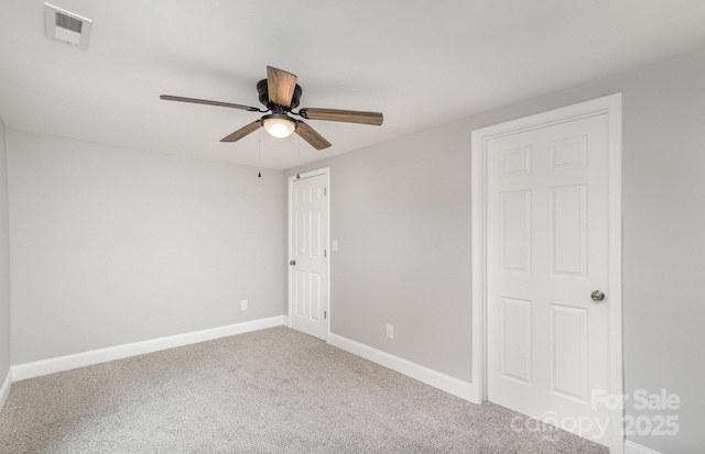 carpeted empty room featuring ceiling fan