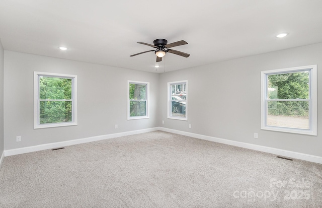 empty room featuring ceiling fan and carpet floors