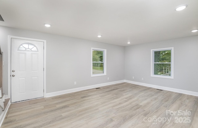 entrance foyer featuring light hardwood / wood-style floors and a healthy amount of sunlight