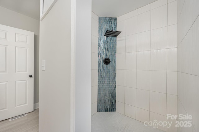 bathroom with a tile shower