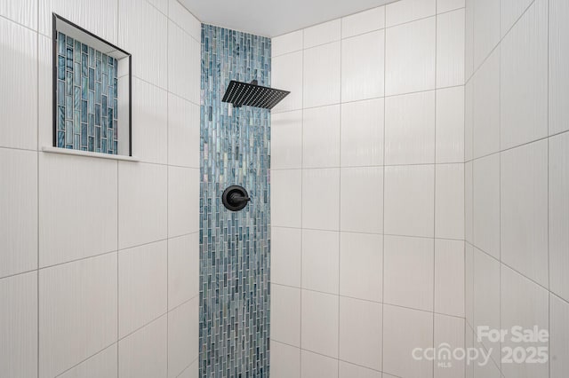 bathroom with tiled shower