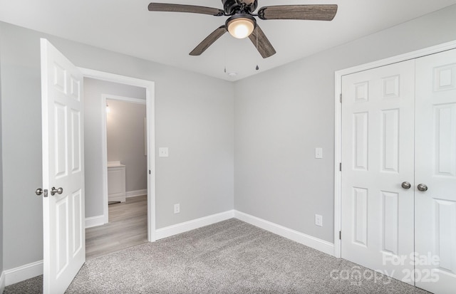 unfurnished bedroom with light colored carpet, ceiling fan, and a closet