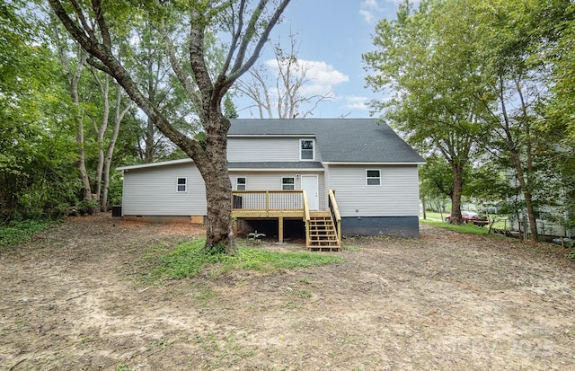 rear view of house with a wooden deck