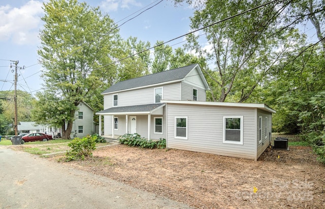 view of property with central air condition unit and a porch