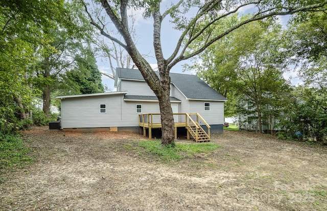 back of property with central AC unit and a deck