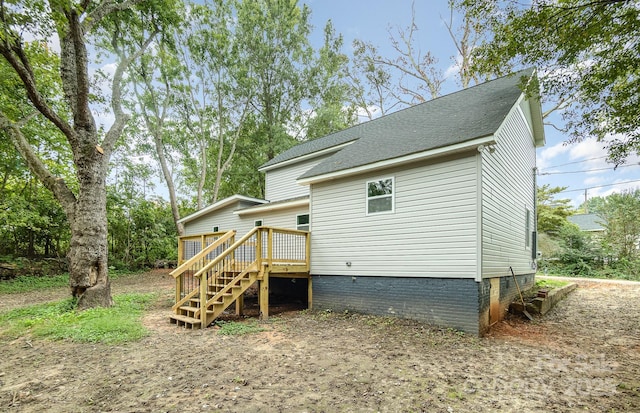 rear view of house featuring a deck