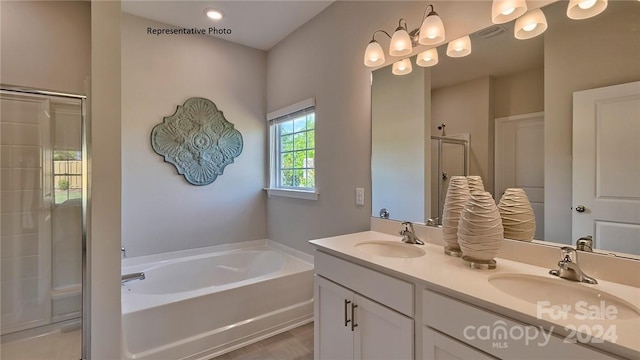 bathroom featuring shower with separate bathtub and vanity