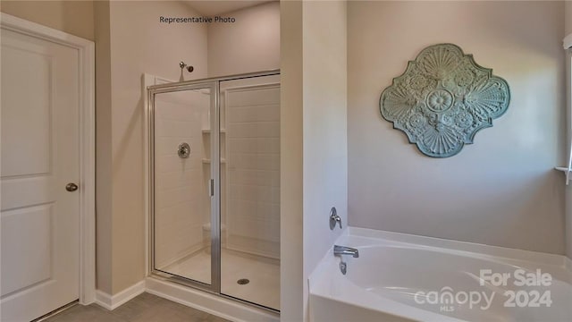 bathroom with separate shower and tub