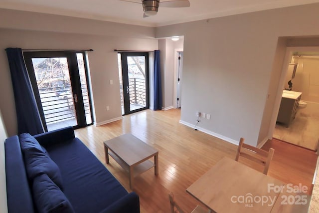 living room with ceiling fan and light wood-type flooring