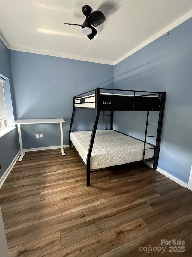 unfurnished bedroom with crown molding, hardwood / wood-style flooring, and ceiling fan