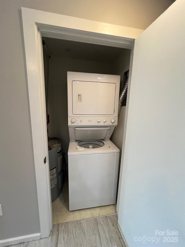 clothes washing area featuring stacked washer / dryer