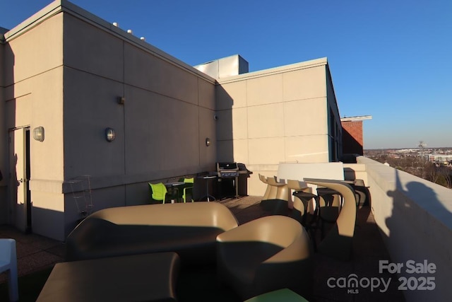 view of patio / terrace with a balcony and a grill