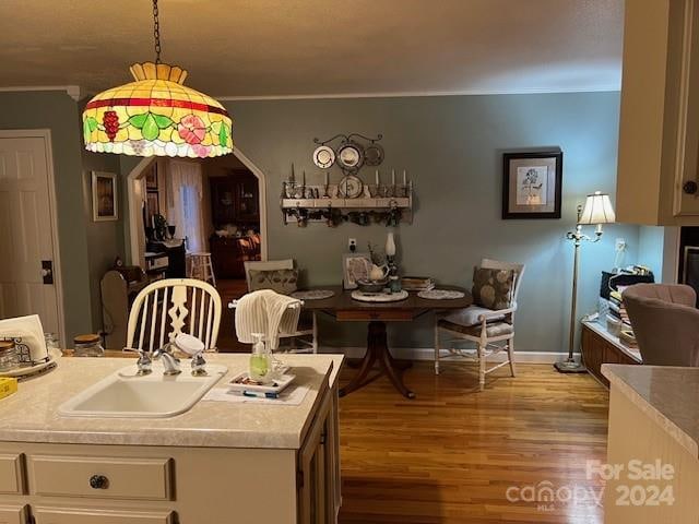 dining area with hardwood / wood-style floors and sink