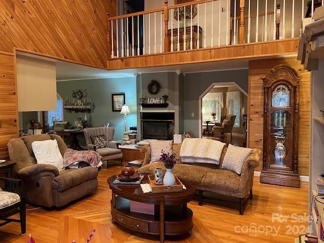 living room with hardwood / wood-style floors and a high ceiling